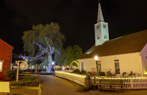 Led lighted tree next to white church