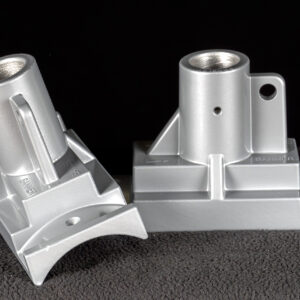 Two Silver brackets on black background used for mounting