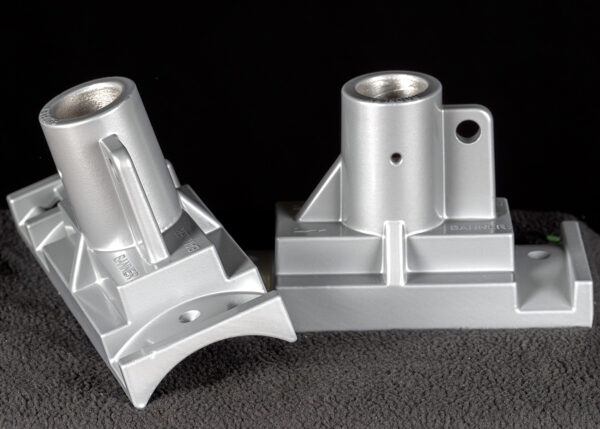 Two Silver brackets on black background used for mounting